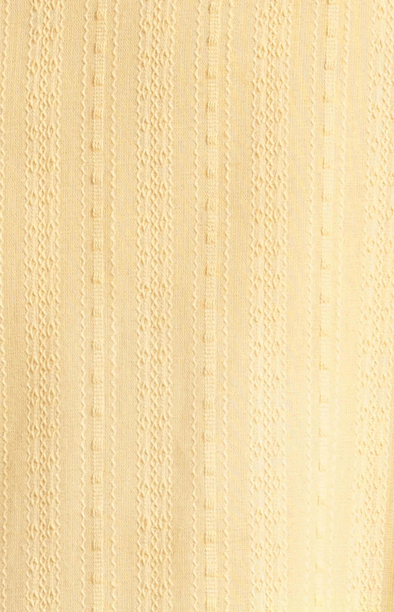 Close-up of a textured yellow fabric surface