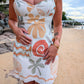 Woman wearing a floral dress on a beach