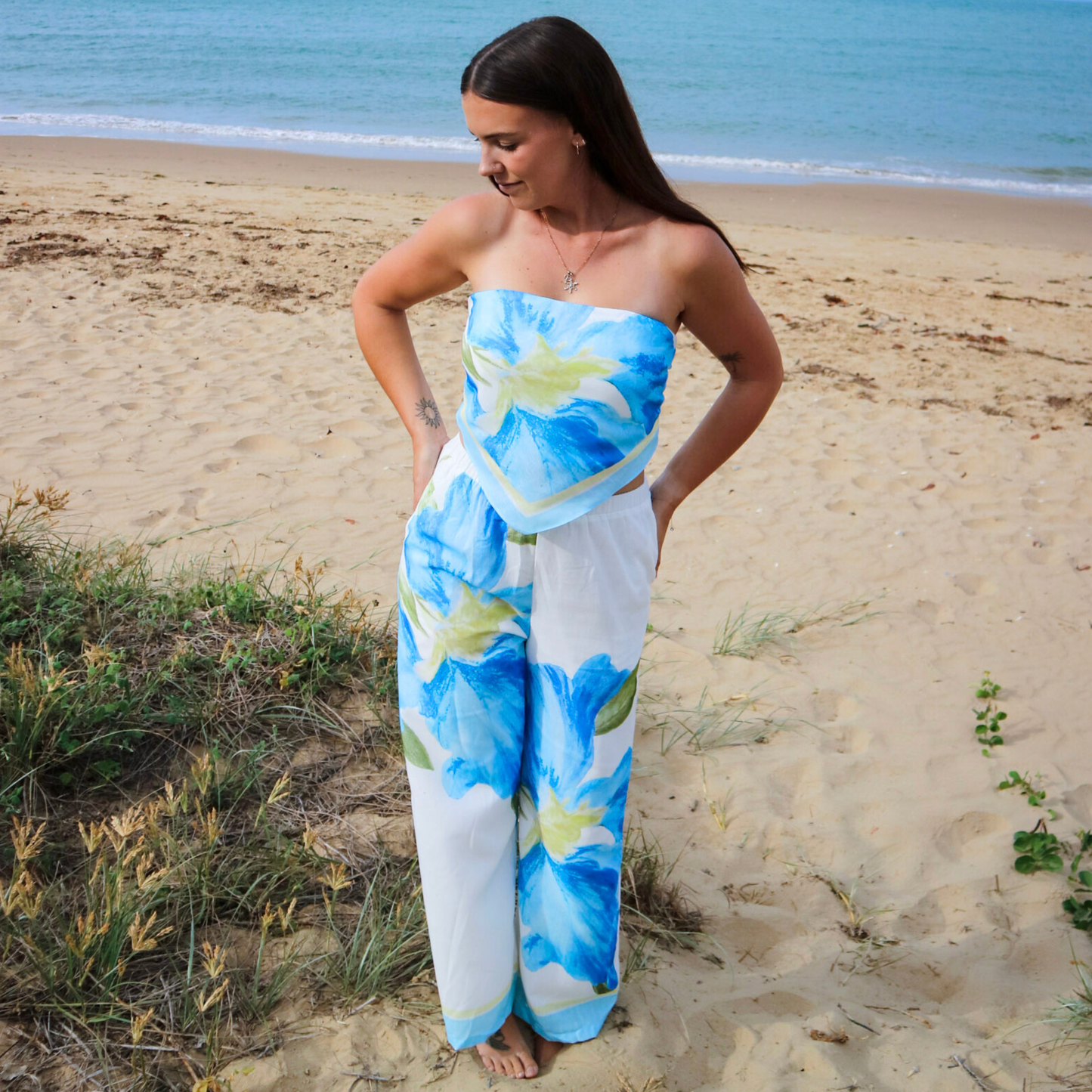 Woman wearing a strapless floral pants set on a beach