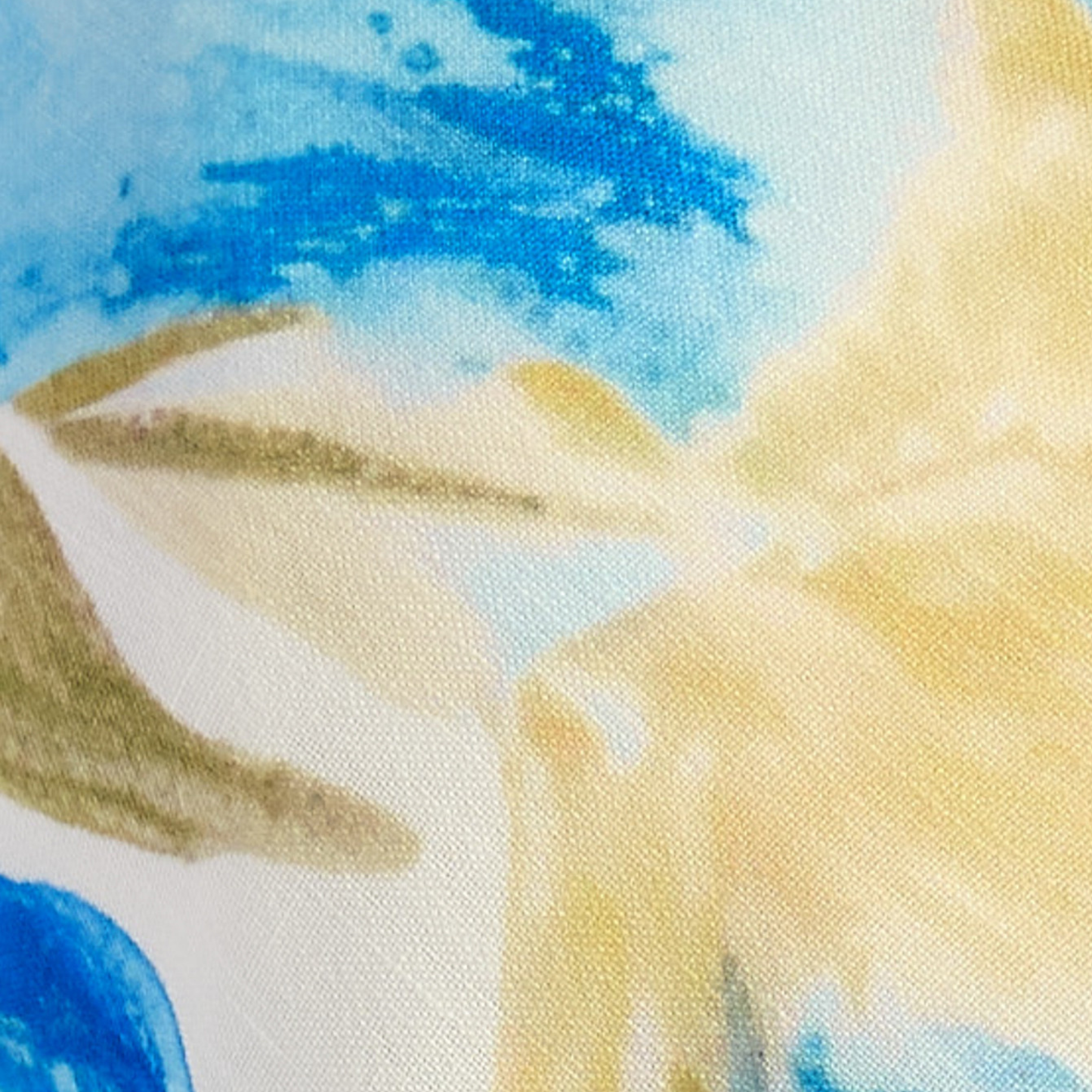 Close-up of a fabric with abstract patterns in blue, beige, and yellow.